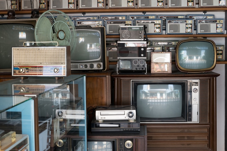 Old vintage different radios, television and electronic in antique store shelves